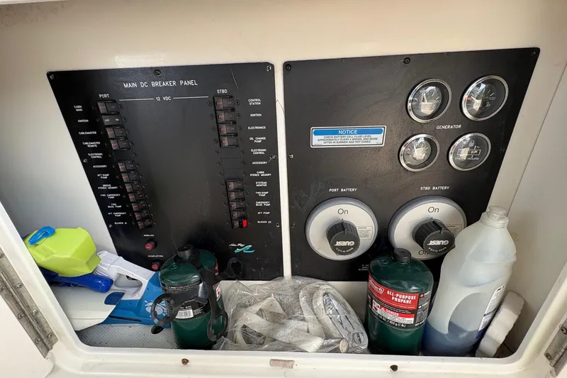 Slide: The Image of Main DC breaker panel on 2001 Sea Ray 460 Sundancer with propane and cleaning supplies. - 60