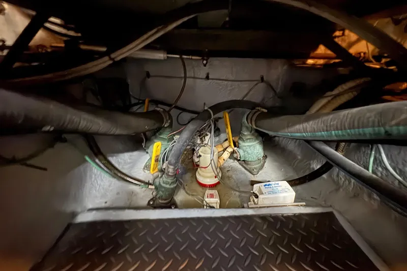 Slide: The Image of Engine room of 2001 Sea Ray 460 Sundancer with visible hoses and equipment. - 61