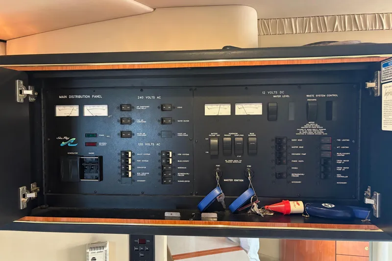 Slide: The Image of Main distribution panel of 2001 Sea Ray 460 Sundancer yacht, featuring electrical controls and gauges. - 62
