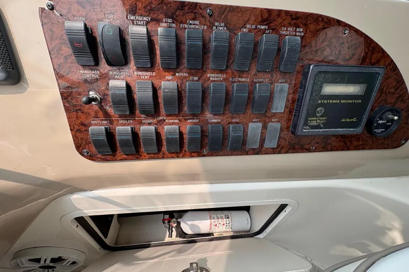 Slide: The Image of Control panel of a 2001 Sea Ray 460 Sundancer boat with switches and systems monitor. - 63