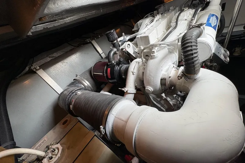 Slide: The Image of Engine compartment of a 2001 Sea Ray 460 Sundancer, showcasing detailed mechanical components. - 69