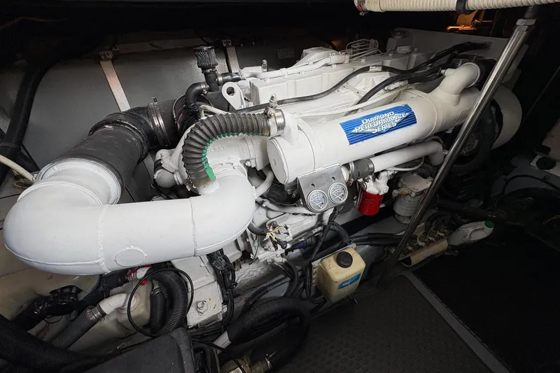 Slide: The Image of Engine compartment of a 2001 Sea Ray 460 Sundancer boat, showcasing mechanical components. - 70