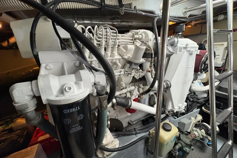 Slide: The Image of Engine room of a 2001 Sea Ray 460 Sundancer yacht, showcasing mechanical components. - 71
