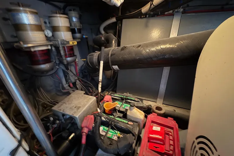 Slide: The Image of Engine room of 2001 Sea Ray 460 Sundancer with batteries and mechanical components. - 72