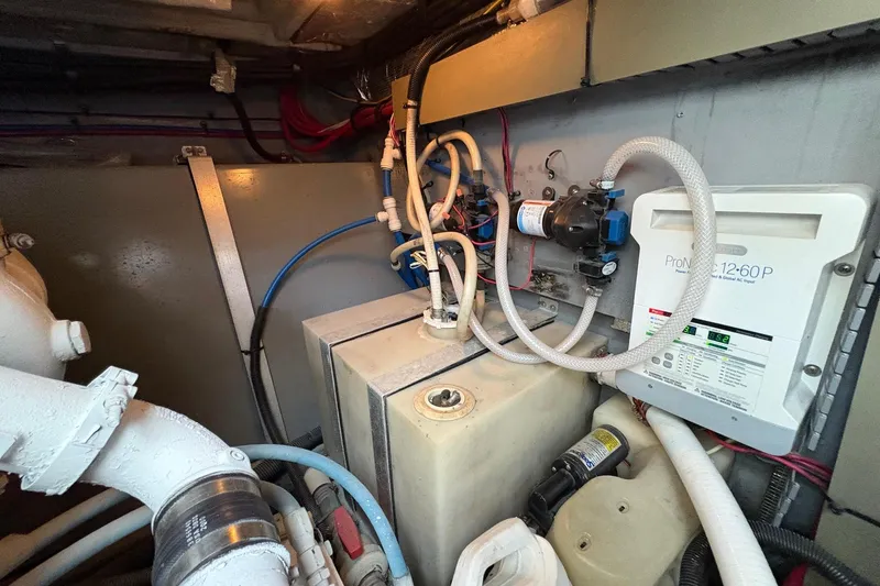 Slide: The Image of Engine room of 2001 Sea Ray 460 Sundancer with various mechanical components and wiring. - 73