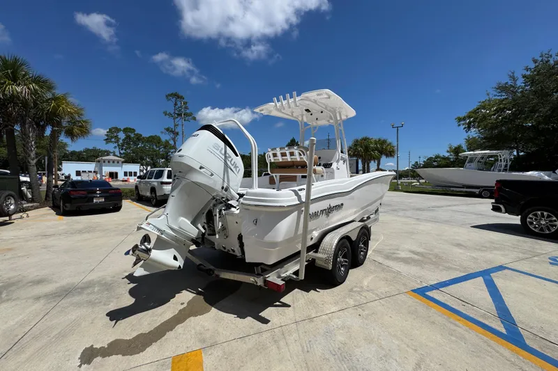 Slide: The Image of 2026 NauticStar 231 Hybrid boat on trailer in sunny parking lot. - 11