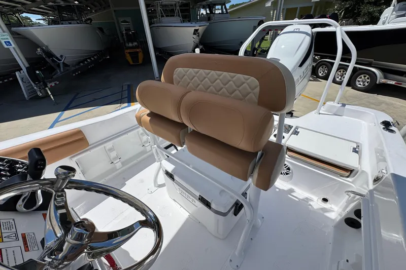 Slide: The Image of 2026 NauticStar 231 Hybrid boat interior with tan seating and steering wheel. - 24