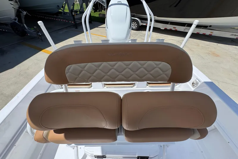 Slide: The Image of 2026 NauticStar 231 Hybrid boat with tan cushioned seating and diamond stitching. - 25