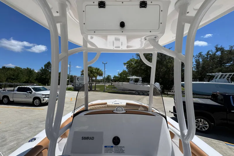 Slide: The Image of 2026 NauticStar 231 Hybrid boat interior with T-top and Simrad electronics. - 28