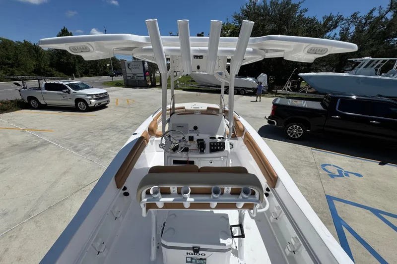 Slide: The Image of 2026 NauticStar 231 Hybrid boat with modern console and seating, parked outdoors. - 30