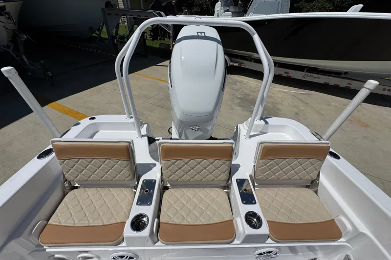 Slide: The Image of 2026 NauticStar 231 Hybrid boat with three cushioned seats and sleek design. - 32