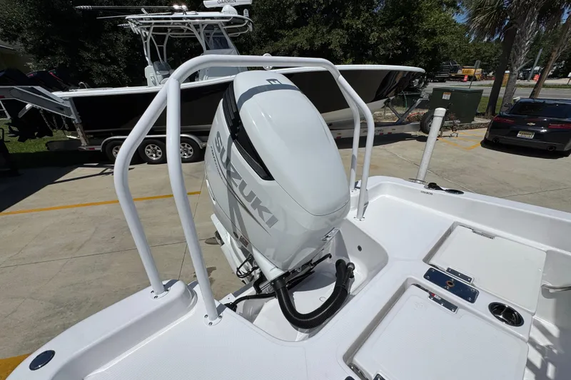 Slide: The Image of 2026 NauticStar 231 Hybrid boat with Suzuki outboard motor in a marina setting. - 34