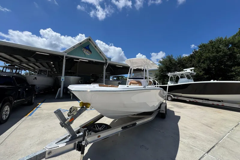 Slide: The Image of 2026 NauticStar 231 Hybrid boat on trailer under clear blue sky. - 4