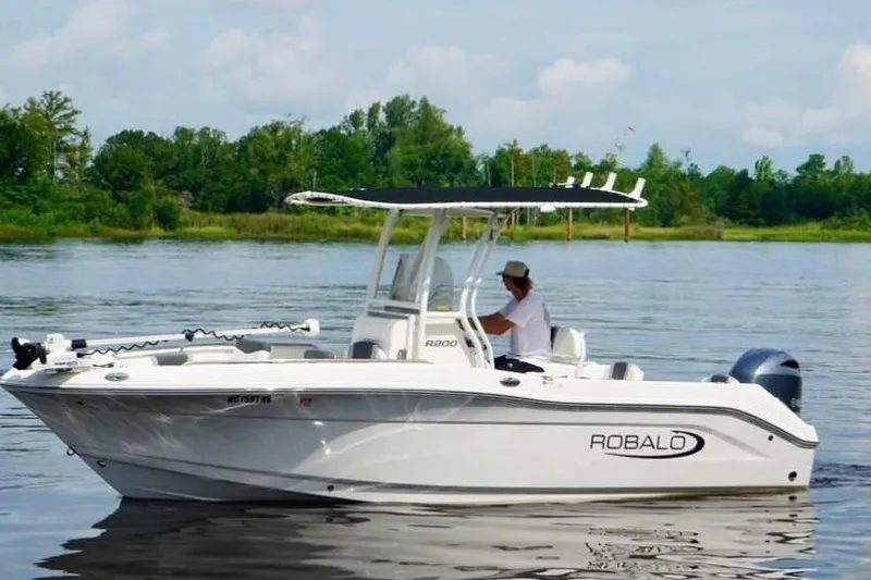 Slide: The Image of 2023 Robalo R200 Center Console boat cruising on a calm lake. - 16