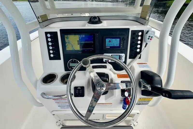 Slide: The Image of 2023 Robalo R200 Center Console boat dashboard with navigation and control systems. - 18