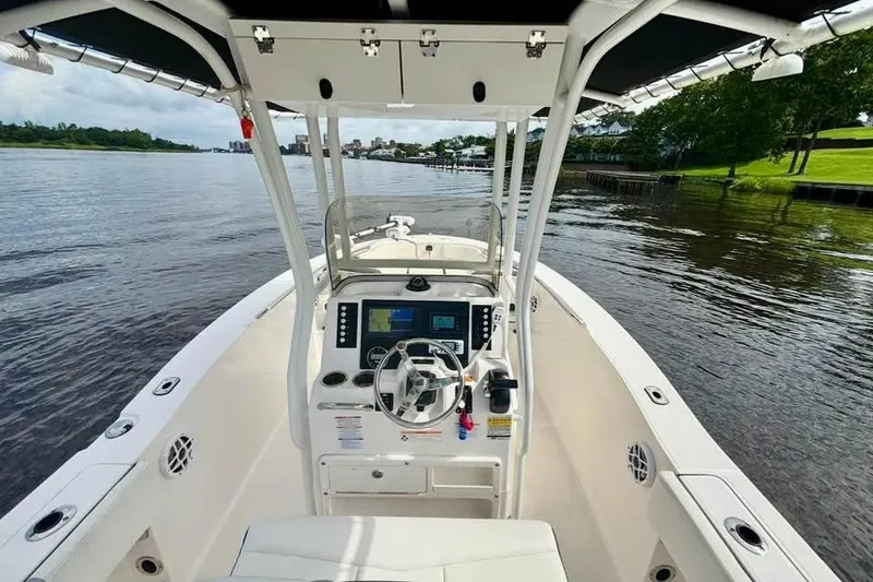 Slide: The Image of 2023 Robalo R200 Center Console boat on calm water, featuring modern dashboard and controls. - 19
