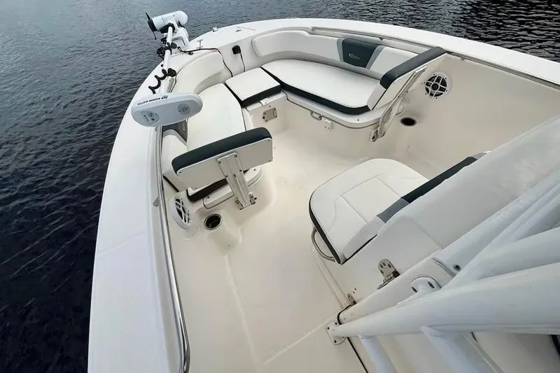 Slide: The Image of 2023 Robalo R200 Center Console boat interior with seating and fishing equipment. - 20