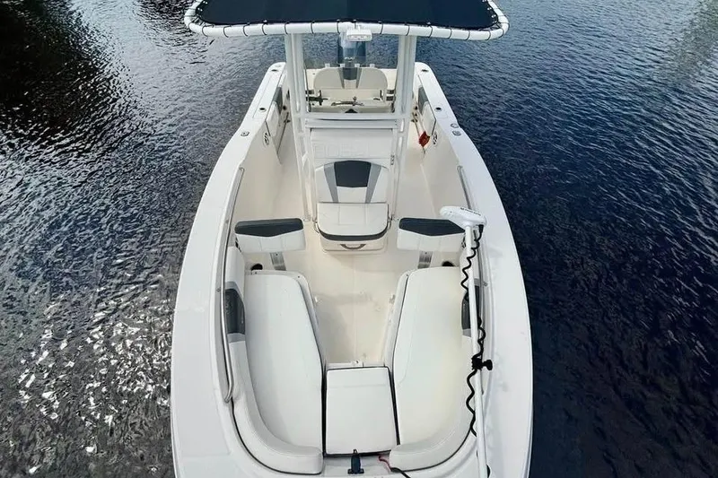 Slide: The Image of 2023 Robalo R200 Center Console boat on water, featuring spacious seating and sleek design. - 21