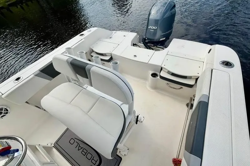 Slide: The Image of 2023 Robalo R200 Center Console boat interior with seating and engine view. - 22