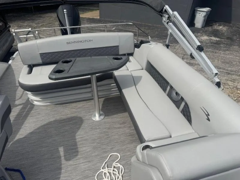 Slide: The Image of 2022 Bennington 25 LSB boat interior with gray seating and table. - 20