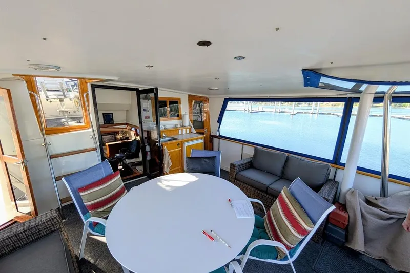 Slide: The Image of Interior of 1990 Carver 55 yacht with seating area and marina view. - 11