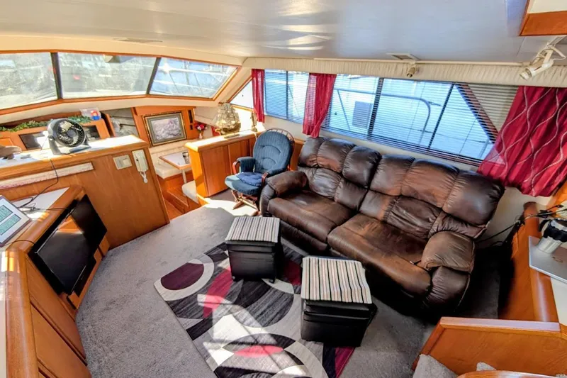 Slide: The Image of Luxurious interior of 1990 Carver 55 yacht with leather sofa and modern decor. - 13