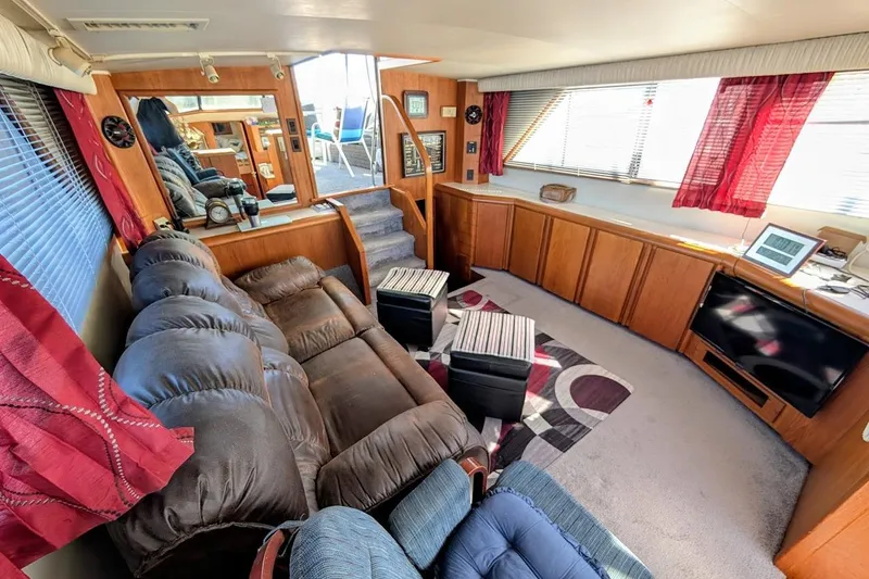 Slide: The Image of Interior of a 1990 Carver 55 yacht with cozy seating and modern amenities. - 15