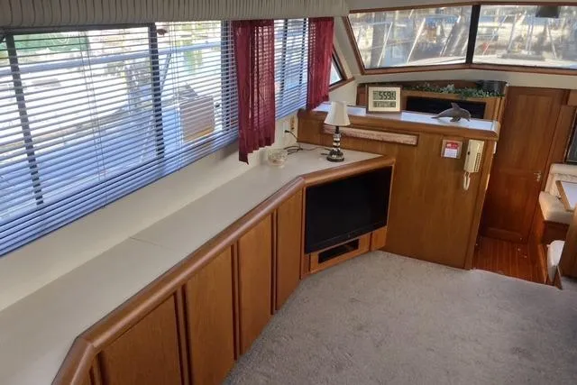 Slide: The Image of Interior of 1990 Carver 55 yacht with wood paneling and large windows. - 16