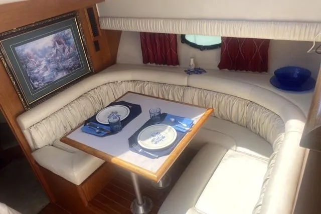 Slide: The Image of Luxurious 1990 Carver 55 yacht interior with elegant dining area and nautical decor. - 20