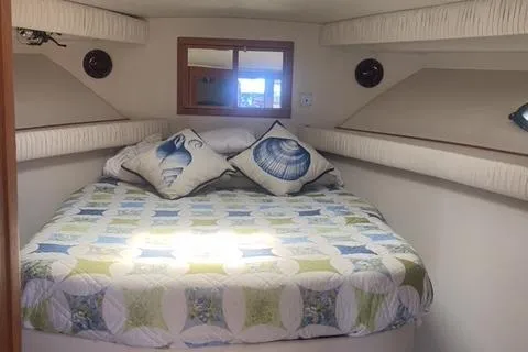 Slide: The Image of Cozy bedroom in 1990 Carver 55 yacht with nautical-themed decor. - 22