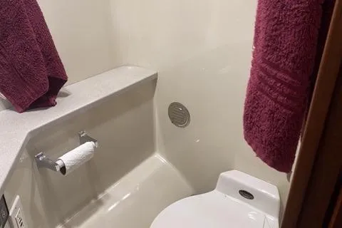 Slide: The Image of Bathroom interior of a 1990 Carver 55 yacht with maroon towels. - 24