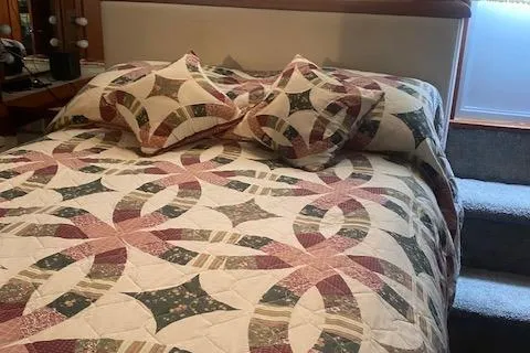 Slide: The Image of Quilted bedspread with geometric patterns in a 1990 Carver 55 interior. - 31