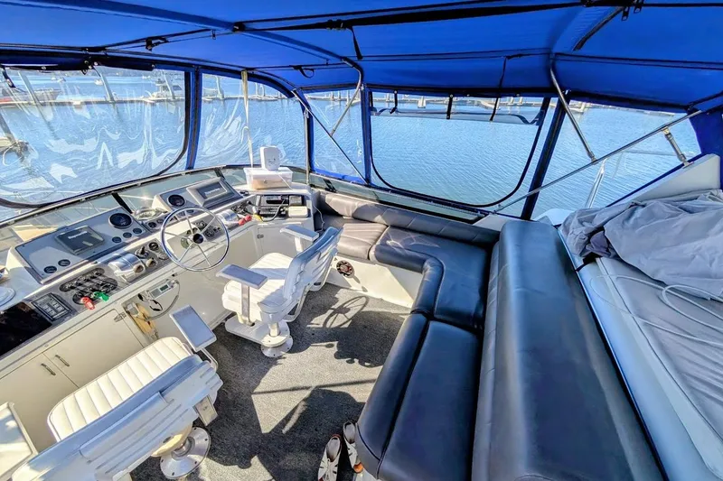 Slide: The Image of Interior of a 1990 Carver 55 yacht with blue canopy and leather seating. - 34