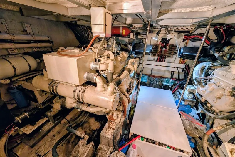 Slide: The Image of Engine room of a 1990 Carver 55 yacht, showcasing mechanical components and wiring. - 40