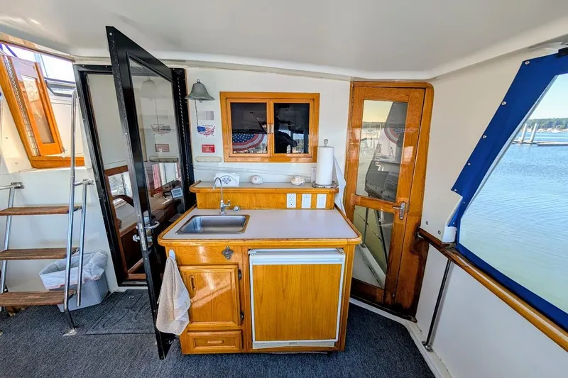 Slide: The Image of Interior of 1990 Carver 55 yacht with kitchenette, sink, and wooden cabinetry. - 12