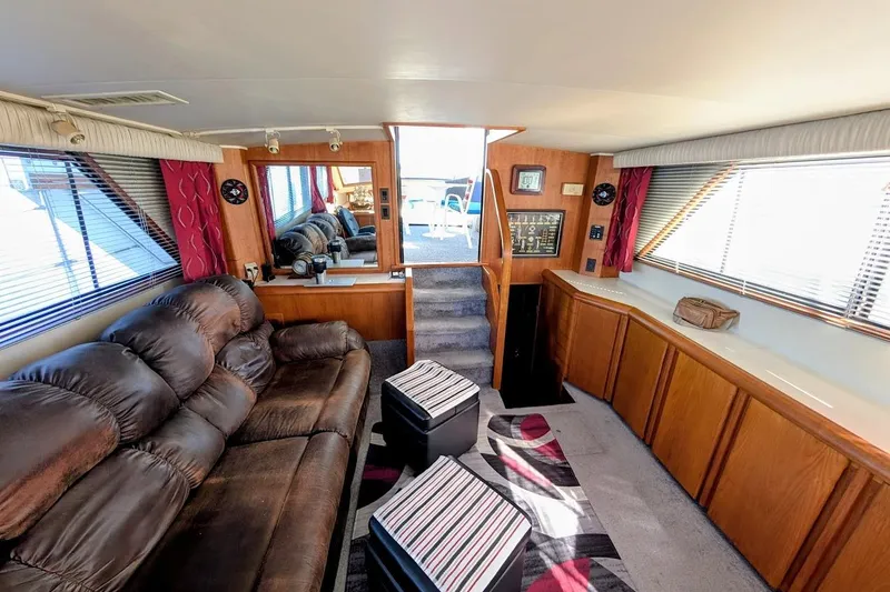 Slide: The Image of Interior of a 1990 Carver 55 yacht with plush seating and wooden cabinetry. - 14