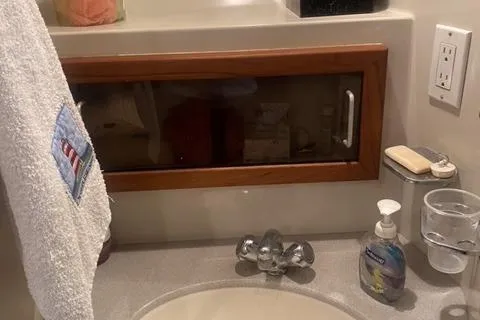 Slide: The Image of Bathroom sink area in a 1990 Carver 55 yacht with towel and soap dispenser. - 25