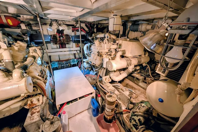 Slide: The Image of Engine room of a 1990 Carver 55 yacht, showcasing complex machinery and equipment. - 41