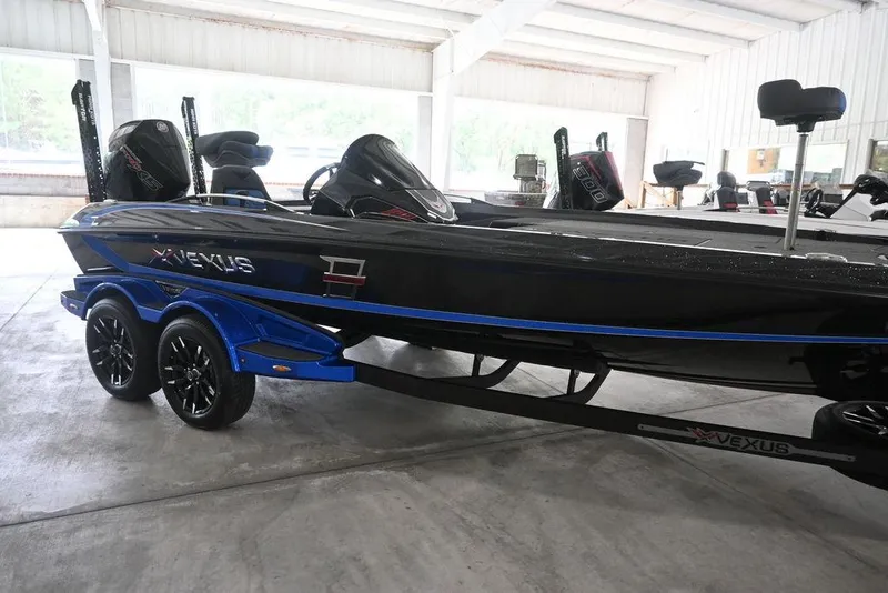 Slide: The Image of 2026 Vexus VX s21 boat in a garage, featuring sleek design and dual motors. - 6