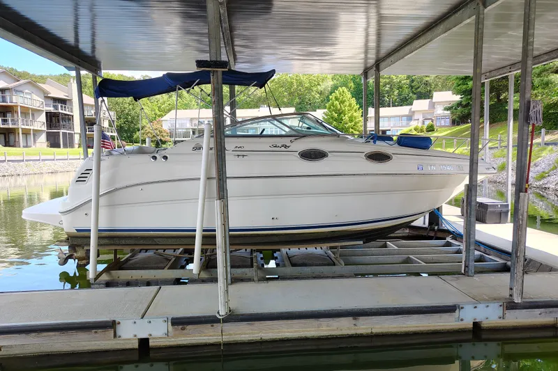 The Image of 2000 Sea Ray 240 Sundancer docked under a covered marina. - 0