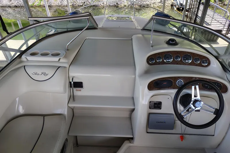 Slide: The Image of 2000 Sea Ray 240 Sundancer boat dashboard with steering wheel and gauges. - 11