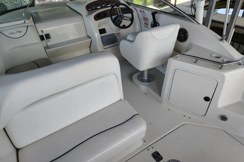 Slide: The Image of Interior of 2000 Sea Ray 240 Sundancer boat, featuring helm and seating area. - 12