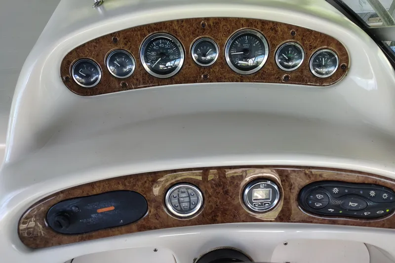 Slide: The Image of Dashboard of a 2000 Sea Ray 240 Sundancer boat with gauges and controls. - 14