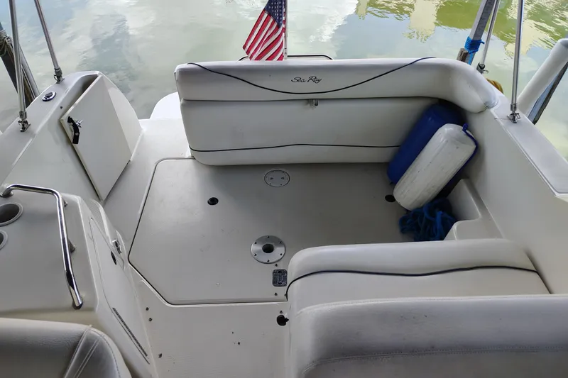 Slide: The Image of 2000 Sea Ray 240 Sundancer boat interior with seating and American flag. - 16