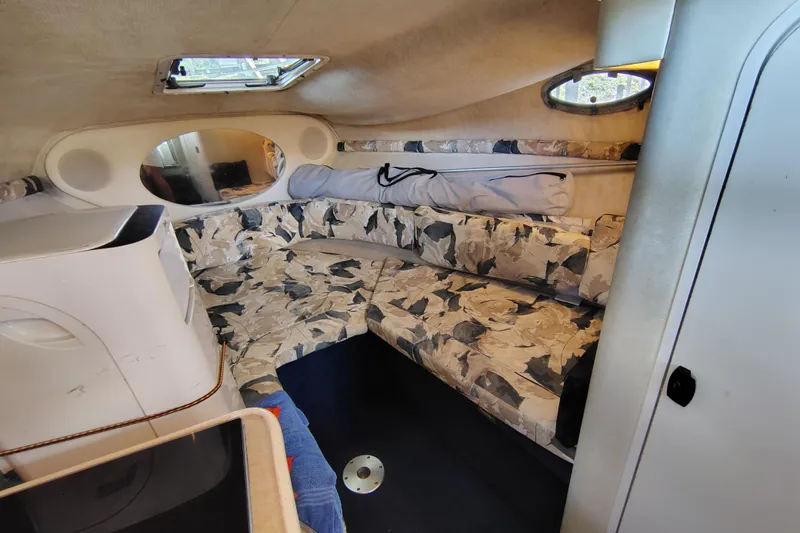 Slide: The Image of Interior of 2000 Sea Ray 240 Sundancer with patterned seating and compact design. - 20