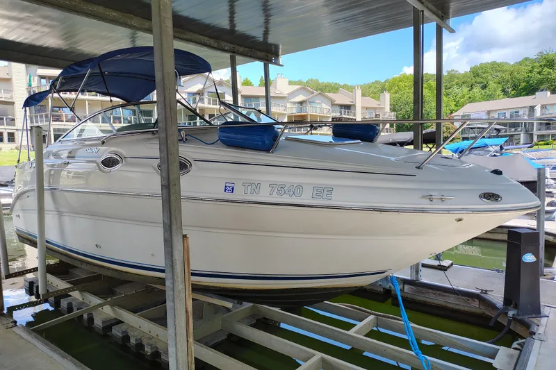 Slide: The Image of 2000 Sea Ray 240 Sundancer boat docked under a covered marina. - 3