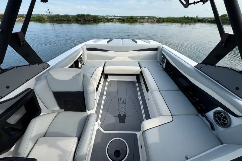 Slide: The Image of 2023 Axis A225 boat interior with spacious seating and modern design on a calm lake. - 11