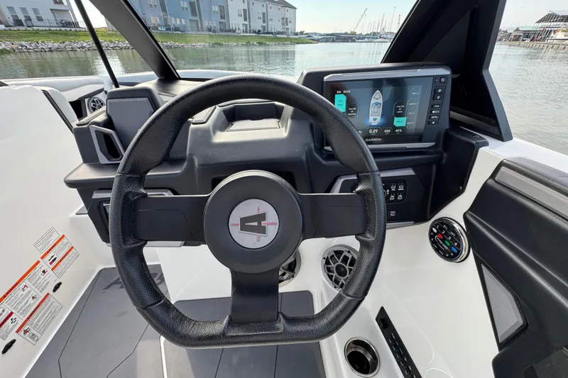 Slide: The Image of Steering wheel and dashboard of 2023 Axis A225 boat with digital display. - 13