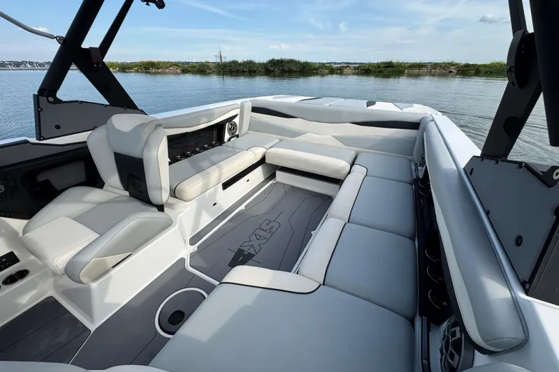 Slide: The Image of 2023 Axis A225 boat interior with spacious seating and modern design on a calm lake. - 16