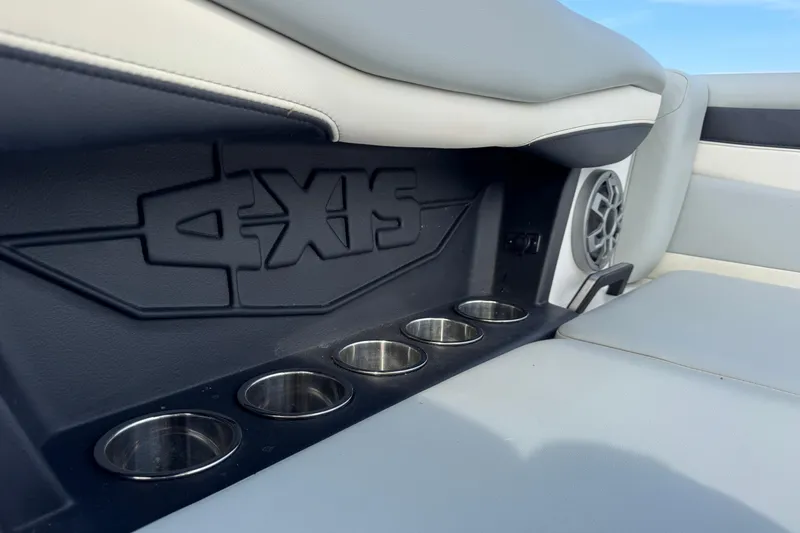 Slide: The Image of 2023 Axis A225 boat interior with cup holders and speaker. - 20